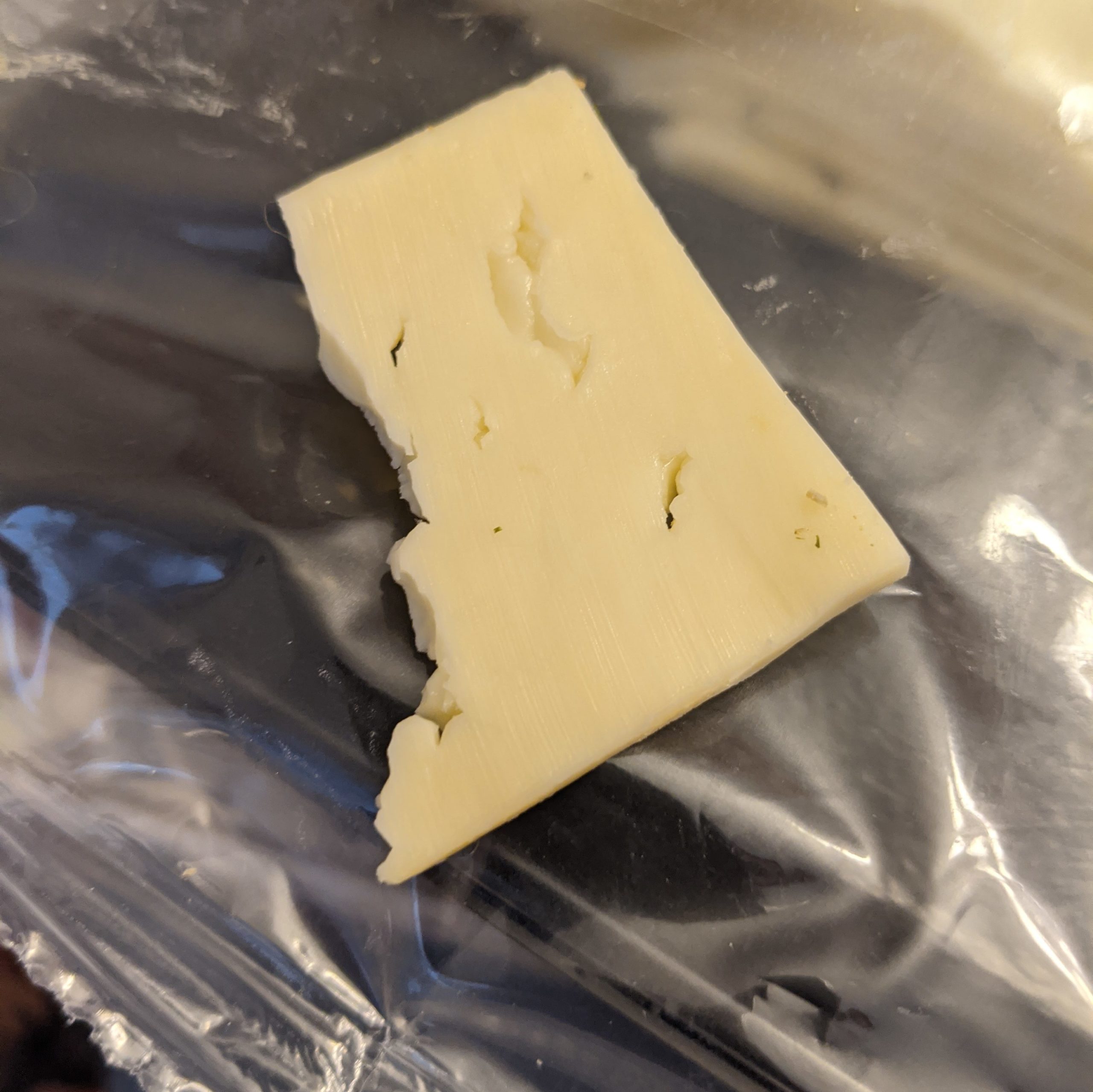 photograph of a slice of gouda in the shape of the District of Columbia